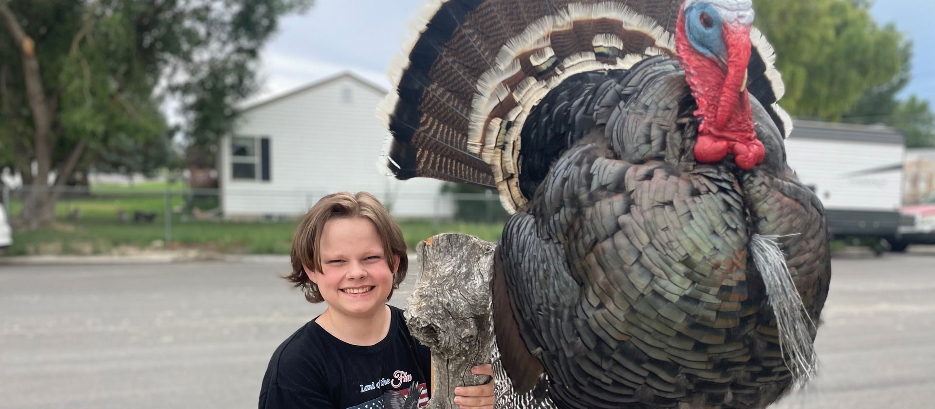 kid holding a giant stuffed turkey